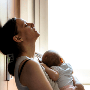 A woman holding her baby in the air.