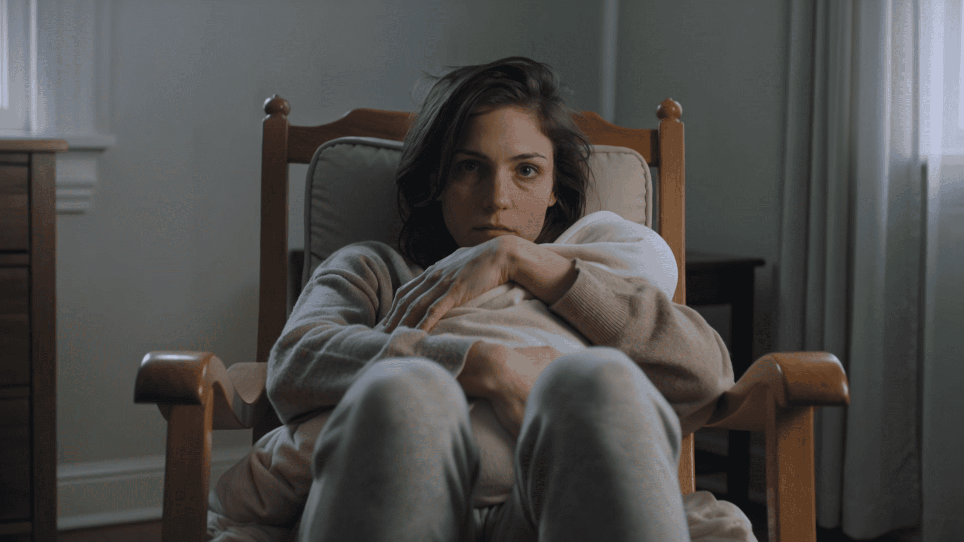Exhausted mother holding her baby, still frame from care video